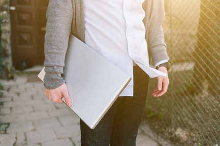 Young stylish man working outdoor with laptopの写真素材