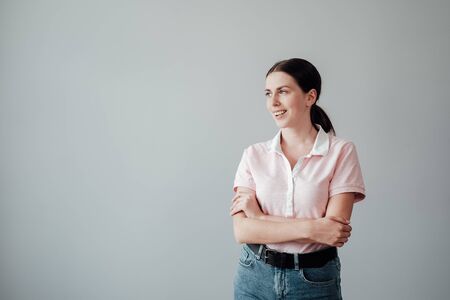 Studio Portrait of Young Adult Pretty Girl Dressed in Pink T-shirt Posing to Camera