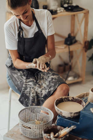Female Pottery Master at Work in Her Clay Studio, Young Entrepreneur Woman Happy Owner of a Small Businessの写真素材