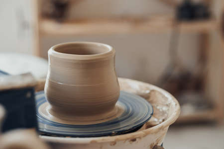 Close Up of Clay Pot on a Pottery Wheel in Ceramic Studio