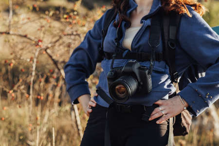 Close Up of Unrecognisable Travel Woman with Backpack and Digital Camera on a Strap Standing on the...