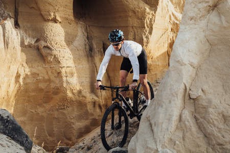 Adult Man Riding Bike Outdoors, Professional Equipped Cyclist on the Trail with Giant Sandy Stonesの写真素材