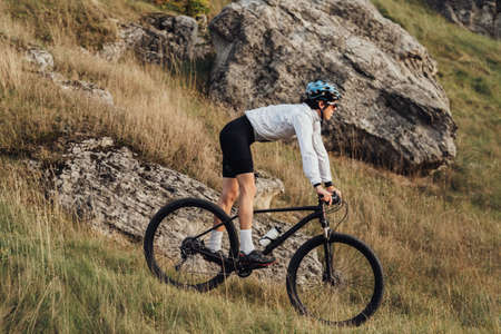 Professional Cyclist Descend from a Hill on a Bicycle, Sportsman Wearing Helmet