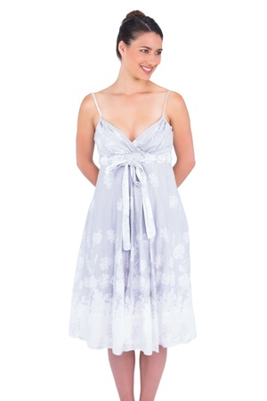Cheerful seductive young model in summer dress posing on white backgroundの写真素材