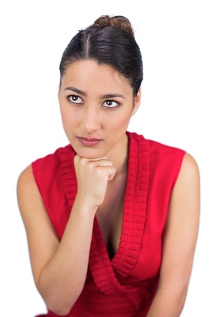Thoughtful tied haired brunette posing on white background の写真素材