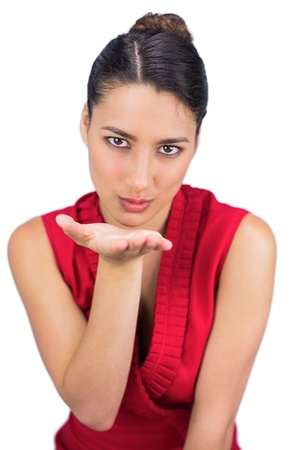 Tied haired brunette sending kissing to camera while posing on white background の写真素材