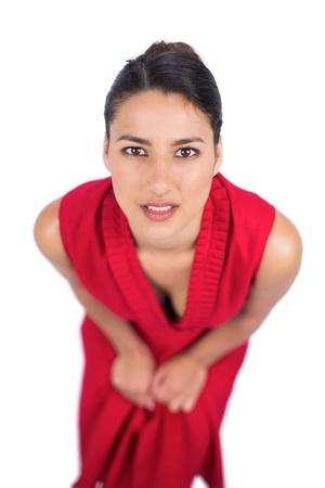 Mysterious brunette in red dress posing on white backgroundの写真素材