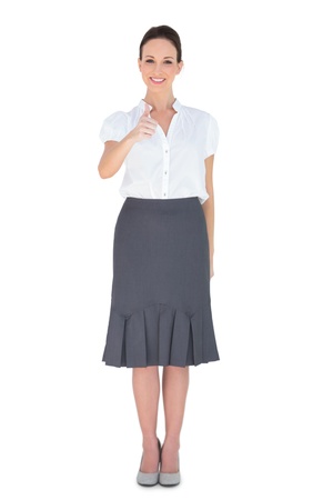Cheerful businesswoman posing thumb up on white backgroundの写真素材