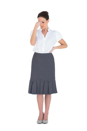 Uneasy gorgeous businesswoman posing on white backgroundの写真素材
