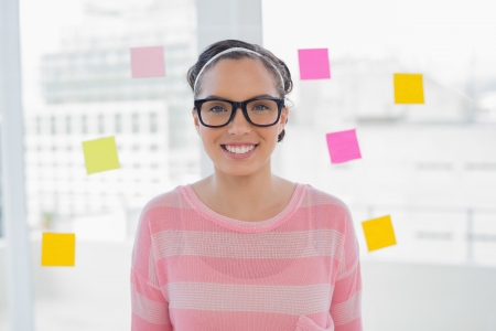 Woman in creative office smiling at cameraの写真素材