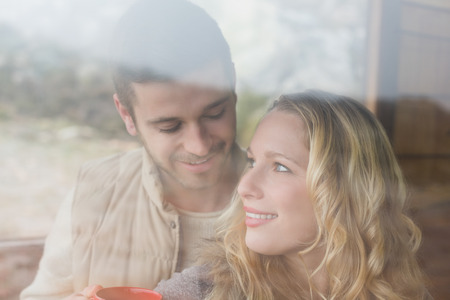 Close up of a content loving young couple seen through cabin windowの写真素材