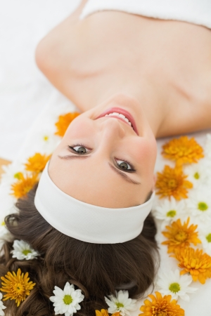Overhead portrait of a beautiful young woman with flowers in beauty salonの写真素材