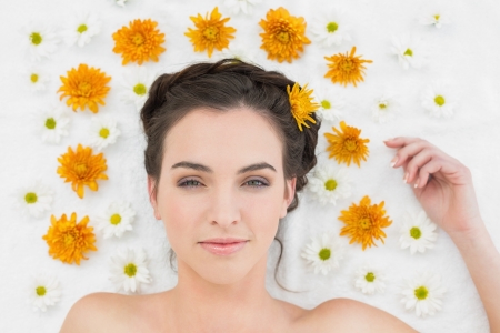 Close up portrait of a beautiful young woman with flowers in beauty salonの写真素材