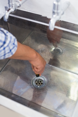 Extreme Close up of a plumber setting a bathroom sinkの写真素材