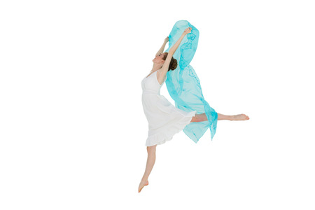 Full length of a young beautiful female dancer with blue scarf against white backgroundの写真素材