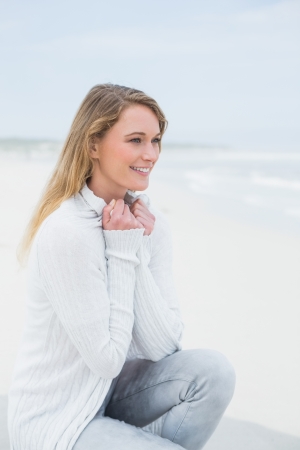 Side view of a smiling casual young woman relaxing at the beachの写真素材