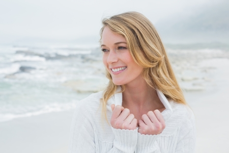 Close-up of a smiling casual young woman relaxing at the beachの写真素材