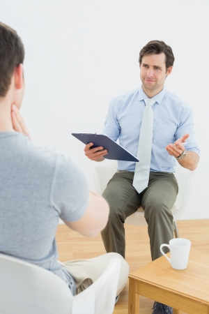 Well dressed male doctor in conversation with patient in the medical officeの写真素材