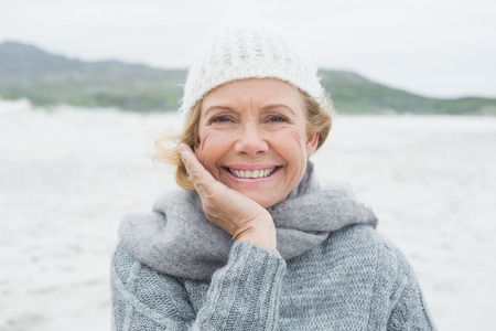 Close-up portrait of a smiling casual senior woman at the beachの写真素材