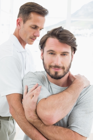 Male physiotherapist examining a young man in the medical officeの写真素材