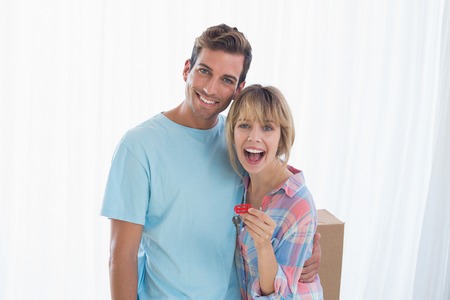 Portrait of a happy young couple holding new house keyの写真素材