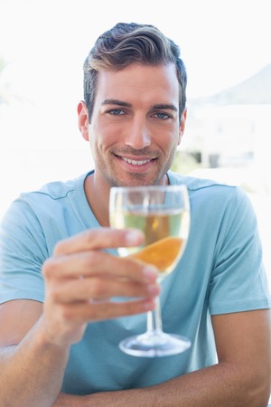 Portrait of a smiling young man holding wine glassの写真素材