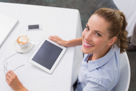 High angle portrait young woman using digital tablet in the coffee shopの写真素材