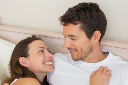 Close-up portrait of a happy young couple at homeの写真素材