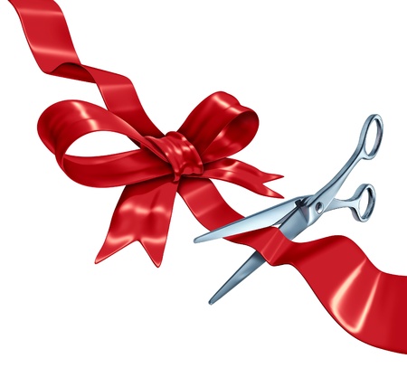 Bow and ribbon cutting with a red silk gift wrapping decoration with scissors opening the present packaging as a holiday symbol for Christmas a birthday or valentine Bow and ribbon cutting with a red silk gift wrapping decoration with scissors opening the present packaging as a holiday symbol for Christmas a birthday or valentine