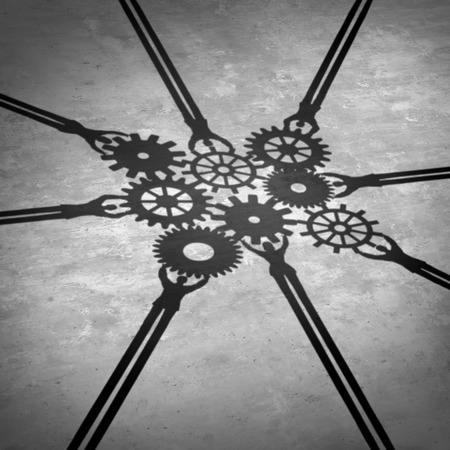 People teamwork holding gears connected together as a social community group symbol or business concept working for a common cause with cast shadows holding a cogwheel network in a corporate team partnership.