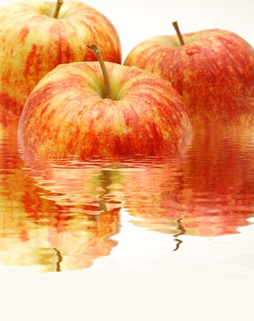 Three apples in waterの写真素材