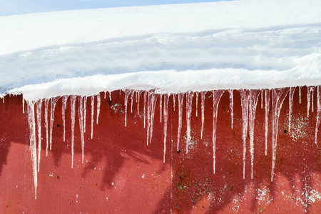 Icicles hanging from the roofの写真素材