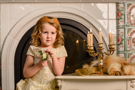 Girl in an ancient dress fireplaceの写真素材
