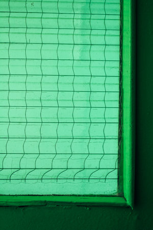 Close up of part of glass green insert in green door, architectural geometry, green textureの写真素材