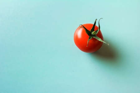 red tomato on a green background from above, colorful minimalismの写真素材