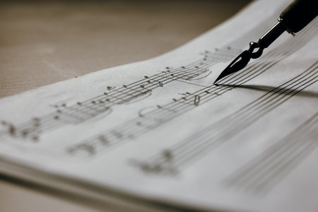 Handwritten music notes macro, music notes with ink pen in the background, selective focusの写真素材