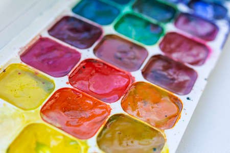 Palette with watercolor multi-colored paints, side view, selective focus, close-up paintsの写真素材