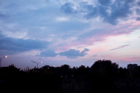 Abstract background evening sky over silhouettes of trees and lanterns