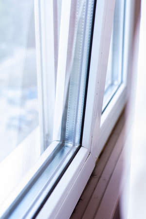 White plastic window on the windowsill in the house. Selective focus.の写真素材
