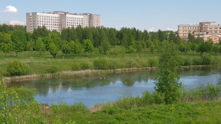 The river is near the city. City Park. Early summer.の写真素材