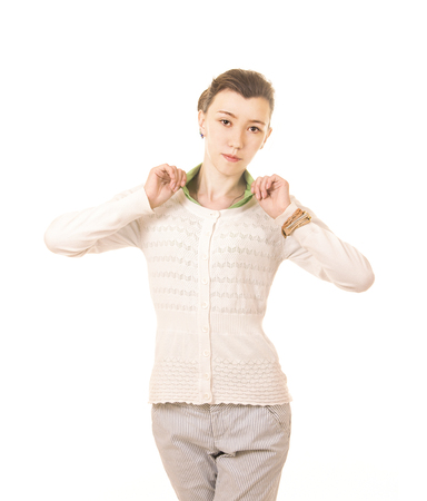 Emotions of a beautiful girl with long hair, in a white jacket posing in Studio on a white background. The isolated image.の写真素材