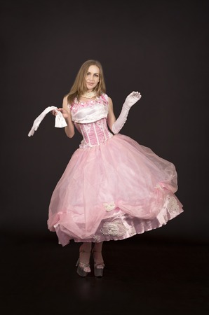 Shooting of a woman in a stage costume on a dark background. Studio shooting.の写真素材