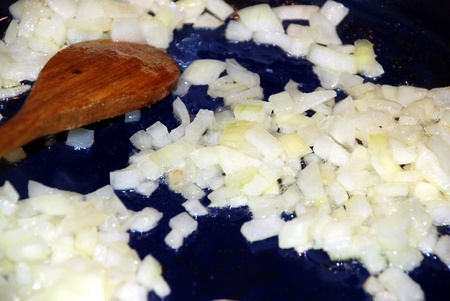 Pieces of black onion, cooking on hot oilの写真素材