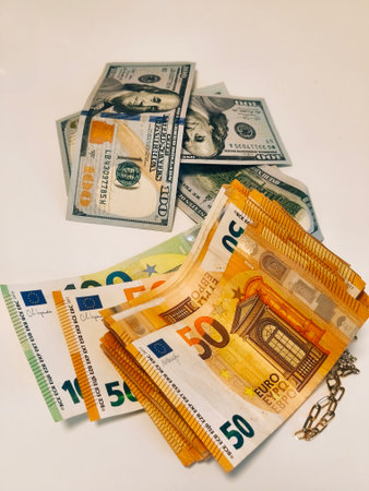 Euro banknotes and coins on a white background, close-upの写真素材