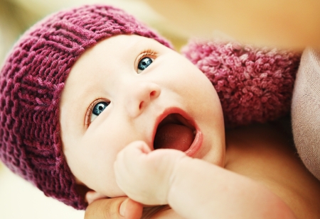 Cute newborn baby in a knit pink hat