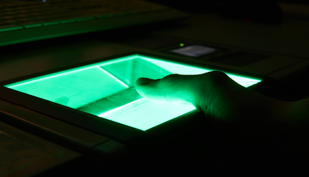 green cybersecurity digital fingerprint scanning on a green screenの写真素材