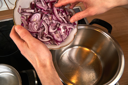Roasting gently onions on a pot with coconut oil.の写真素材
