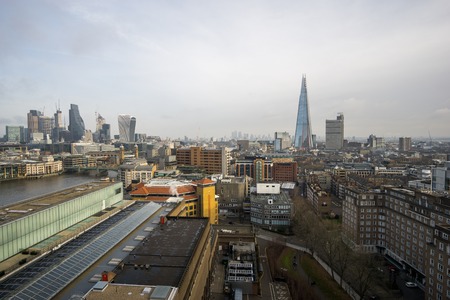 The Shard skyscraper with grey clouds in the sky.の写真素材