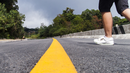 Running through Yellow Line along the Roadの写真素材