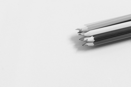 Colored pencils lined up in a row in black and white effectの写真素材